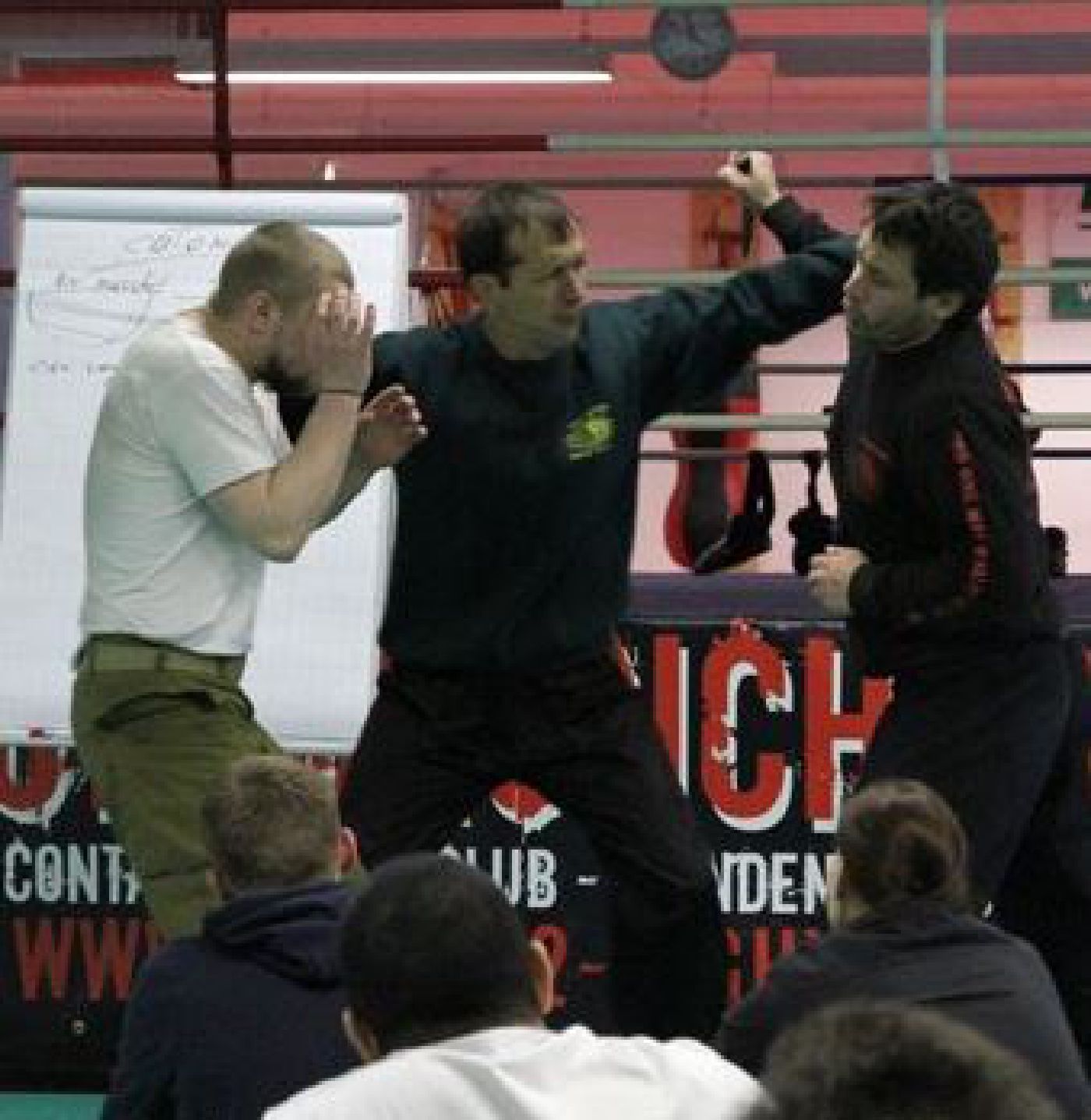 Krav Maga instructor demonstrating how to protect someone from an assailant