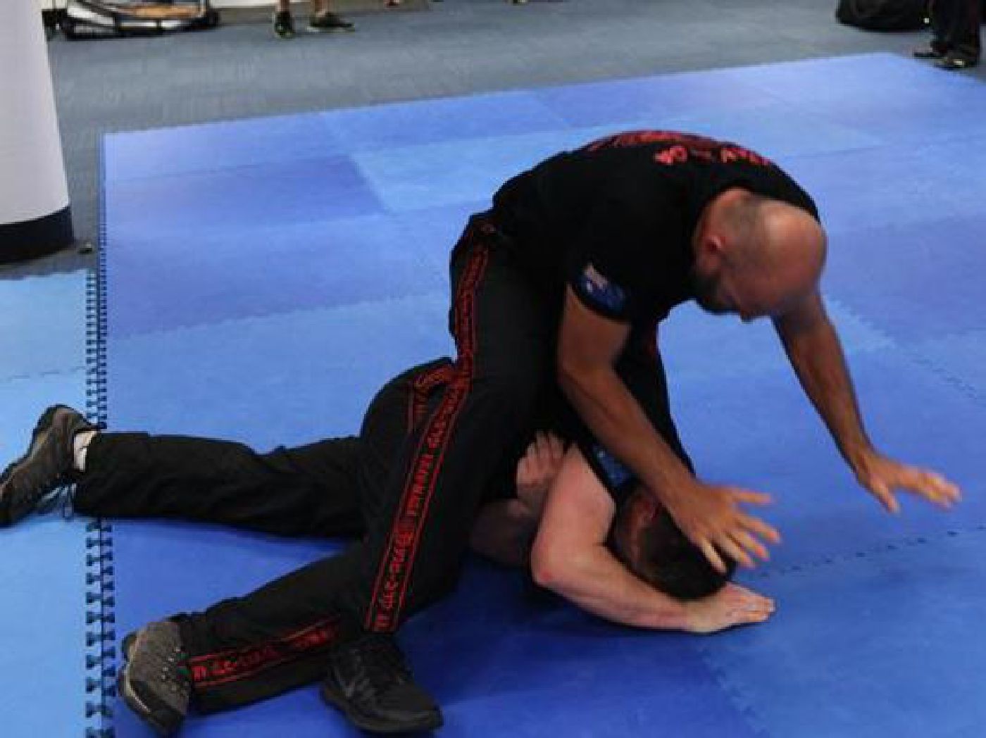 Krav Maga practitioners practicing ground defense and escape drills
