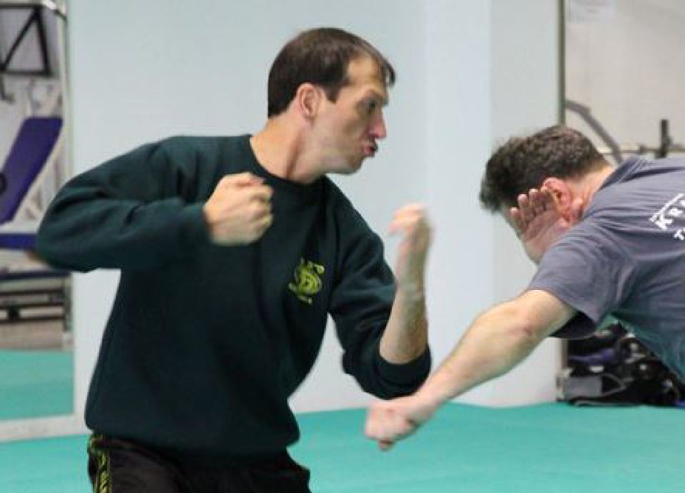 Krav Maga Instructor demonstrating how to deflect an attacker's punch to counter